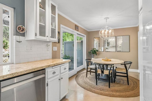 dining area featuring a chandelier, crown molding, and baseboards
