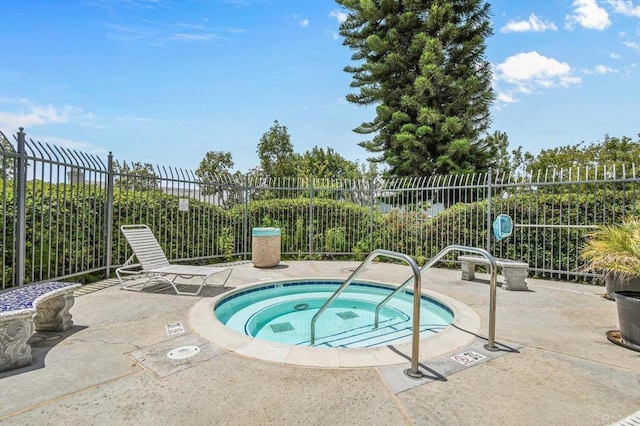 view of pool featuring a hot tub, fence, and a patio area