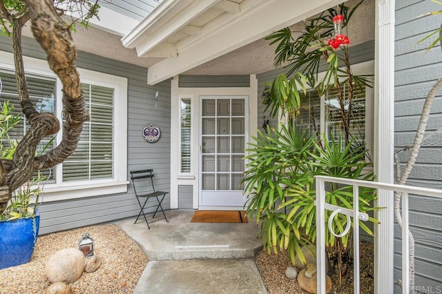 view of exterior entry with covered porch