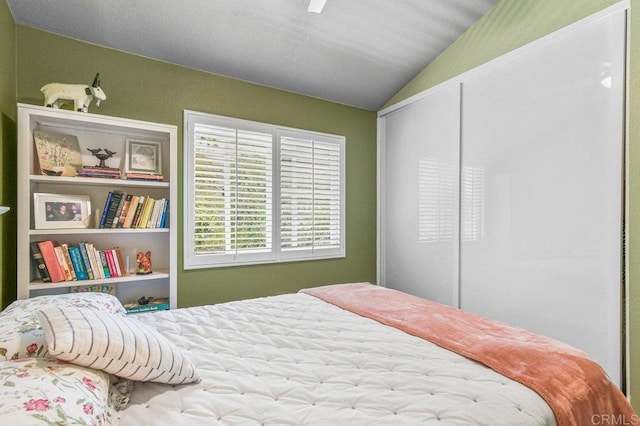 bedroom featuring lofted ceiling and a ceiling fan