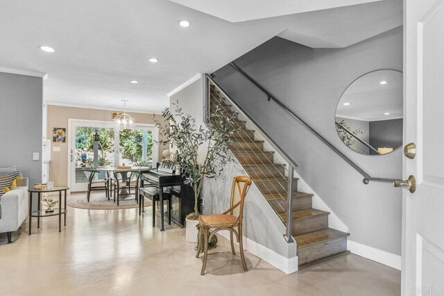 stairway with recessed lighting, crown molding, finished concrete floors, and baseboards