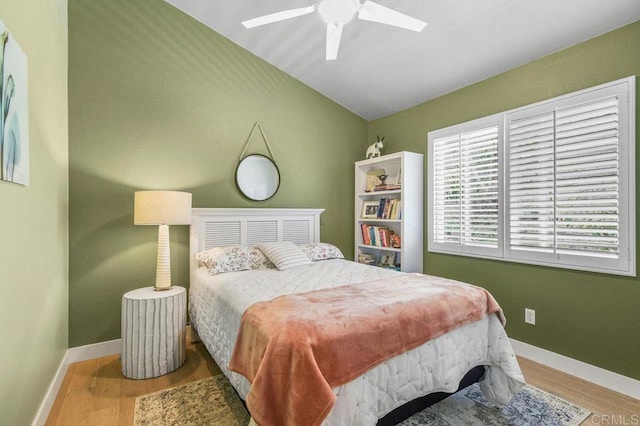 bedroom with baseboards, wood finished floors, and a ceiling fan