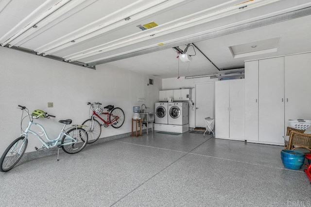 garage with washer and clothes dryer and a garage door opener