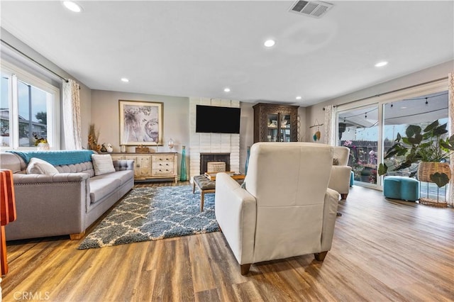 340 Terry Way, La Habra, CA 90631 - living area featuring wood finished floors, plenty of natural light, a brick fireplace, and recessed lighting