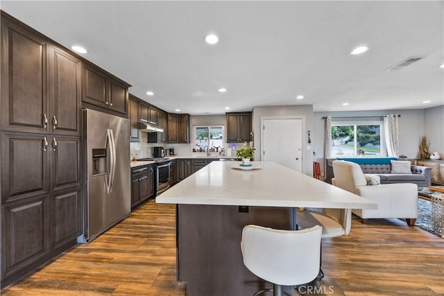 340 Terry Way, La Habra, CA 90631 - kitchen featuring appliances with stainless steel finishes, dark wood-type flooring, a center island, dark brown cabinetry, and open floor plan