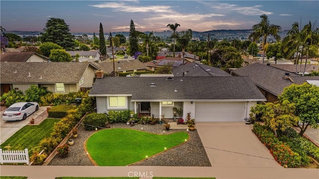 340 Terry Way, La Habra, CA 90631 - view of front facade with concrete driveway, a garage, and roof with shingles