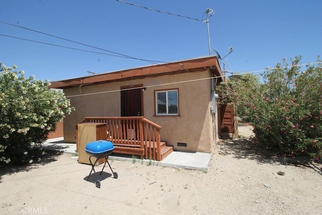 404 N 4th Ave, Barstow, CA 92311 - back of property featuring crawl space, stucco siding, and a patio area