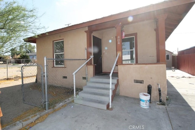 404 N 4th Ave, Barstow, CA 92311 - property entrance featuring a gate and stucco siding