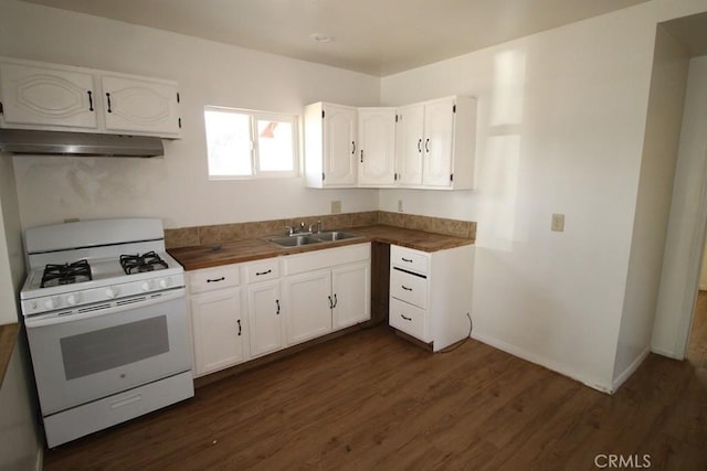 404 N 4th Ave, Barstow, CA 92311 - kitchen featuring white range with gas stovetop, under cabinet range hood, a sink, dark wood-style floors, and white cabinetry