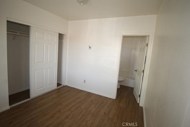 404 N 4th Ave, Barstow, CA 92311 - unfurnished bedroom featuring wood finished floors, a closet, baseboards, and ensuite bathroom