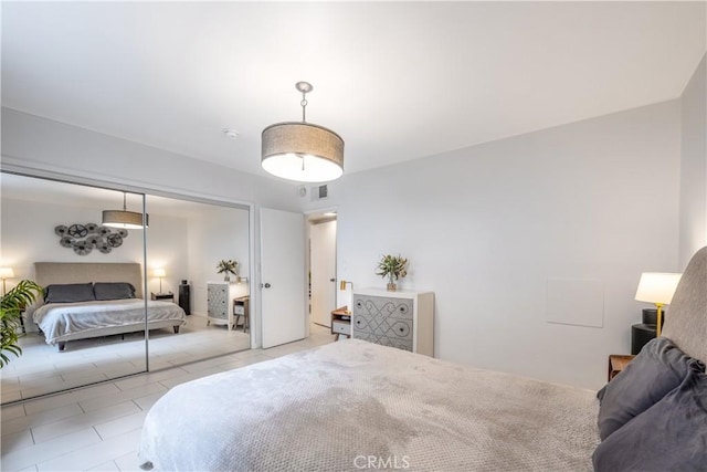 bedroom featuring a closet and light tile patterned floors