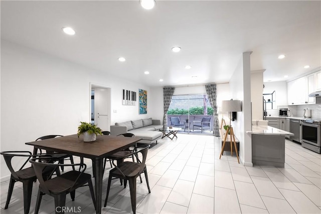 dining room featuring recessed lighting, baseboards, and light tile patterned flooring