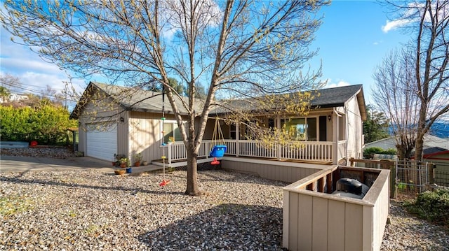 18863 Stonegate Rd, Hidden Valley Lake, CA 95467 - view of front of house with a porch, fence, concrete driveway, roof with shingles, and a garage