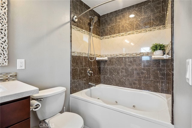 full bathroom featuring toilet, vanity, and a combined bath / shower with jetted tub