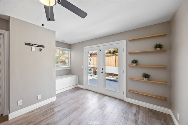 entryway with french doors, ceiling fan, wood finished floors, and baseboards
