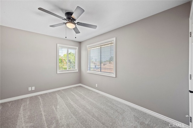 unfurnished room with baseboards, carpet flooring, and ceiling fan