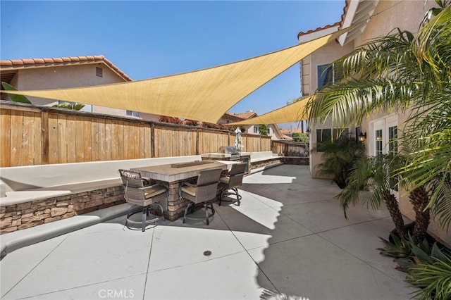 view of patio with a fenced backyard and outdoor dining area