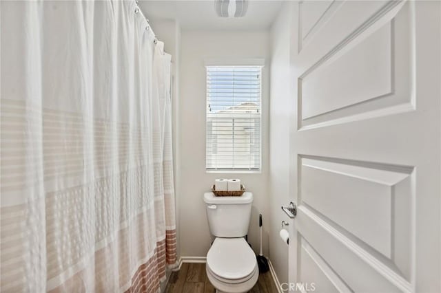 148 Camden Ct, Perris, CA 92571 - bathroom featuring wood finished floors, toilet, and baseboards