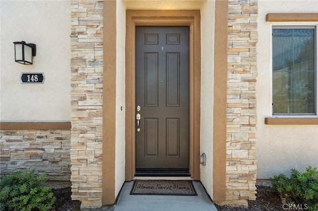 148 Camden Ct, Perris, CA 92571 - view of exterior entry featuring stone siding and stucco siding
