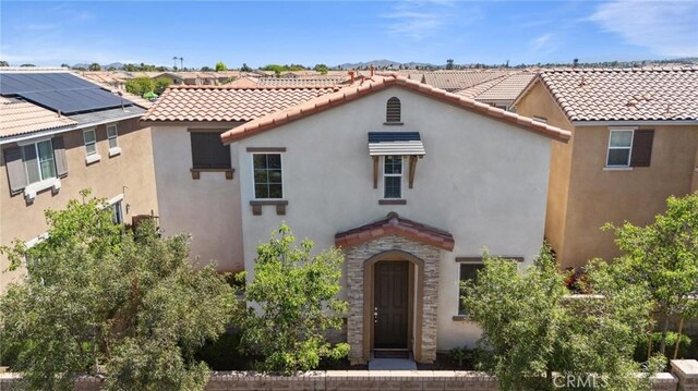 148 Camden Ct, Perris, CA 92571 - mediterranean / spanish-style home with a tiled roof, stucco siding, and stone siding