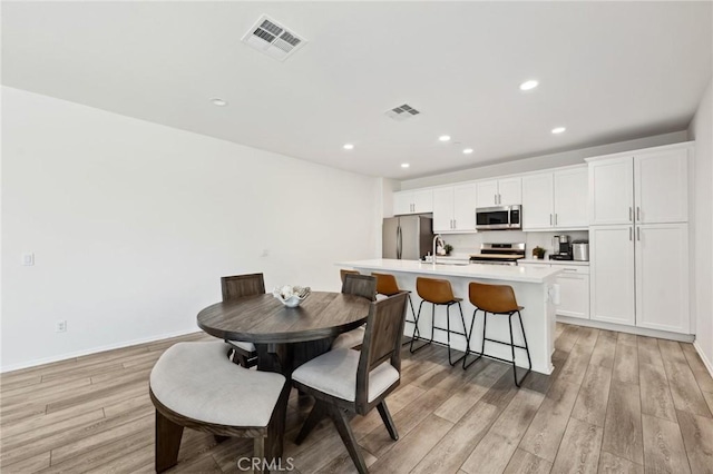 148 Camden Ct, Perris, CA 92571 - dining space featuring light wood-type flooring, recessed lighting, and baseboards