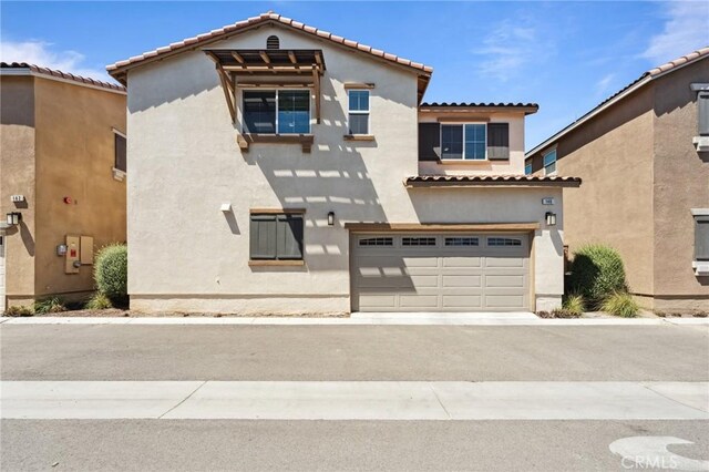 148 Camden Ct, Perris, CA 92571 - view of front facade with stucco siding, a garage, a tiled roof, and driveway