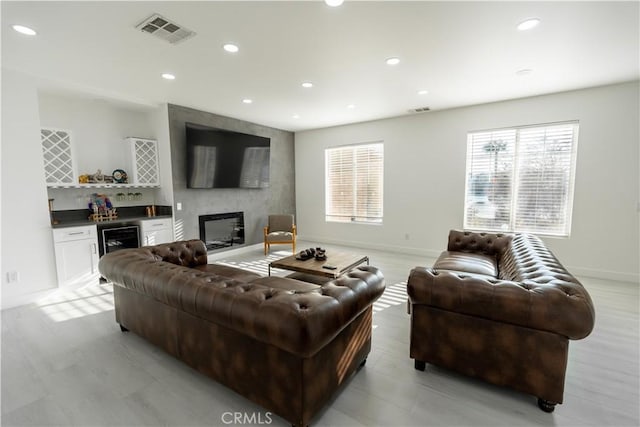 43250 Lago Brezza Dr, Indio, CA 92203 - living room featuring a bar, beverage cooler, recessed lighting, baseboards, and a fireplace