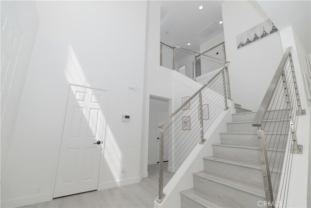 43250 Lago Brezza Dr, Indio, CA 92203 - staircase with baseboards, a high ceiling, wood finished floors, and recessed lighting