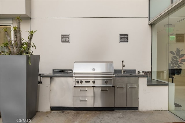 view of patio / terrace featuring a sink, an outdoor kitchen, and a grill