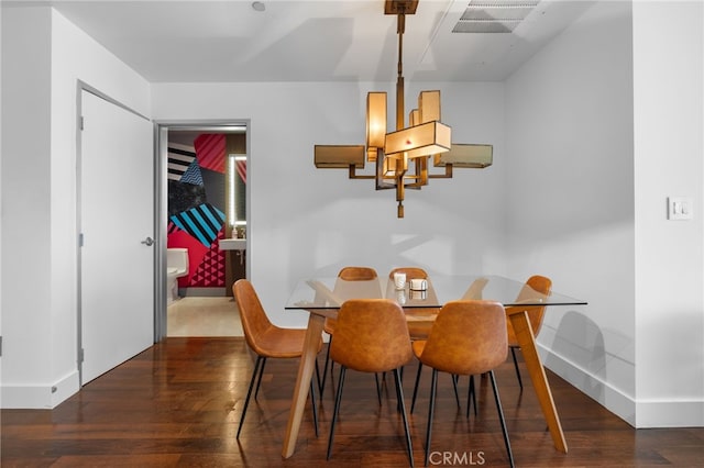 dining area featuring wood finished floors and baseboards