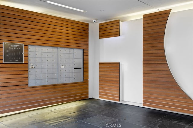view of community featuring mail area and wooden walls
