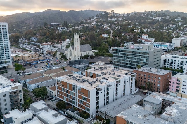 aerial view at dusk of a mountain view and a city view