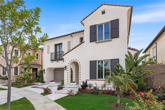244 Coal Mine, Irvine, CA 92602 - mediterranean / spanish home featuring a balcony, stucco siding, a front yard, and a tiled roof