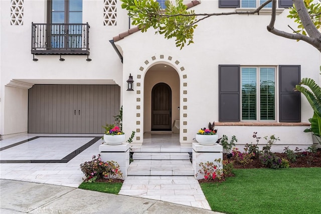 244 Coal Mine, Irvine, CA 92602 - view of exterior entry featuring a balcony, stucco siding, and a garage