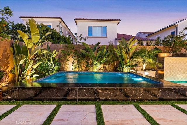 244 Coal Mine, Irvine, CA 92602 - pool at dusk featuring a fenced backyard and a patio area