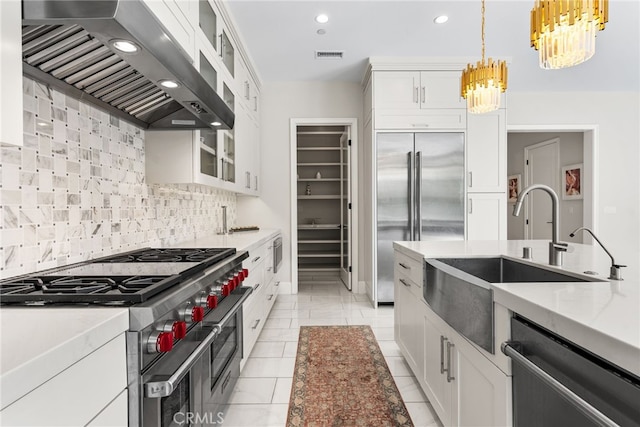 244 Coal Mine, Irvine, CA 92602 - kitchen featuring high end appliances, wall chimney range hood, a sink, a chandelier, and tasteful backsplash