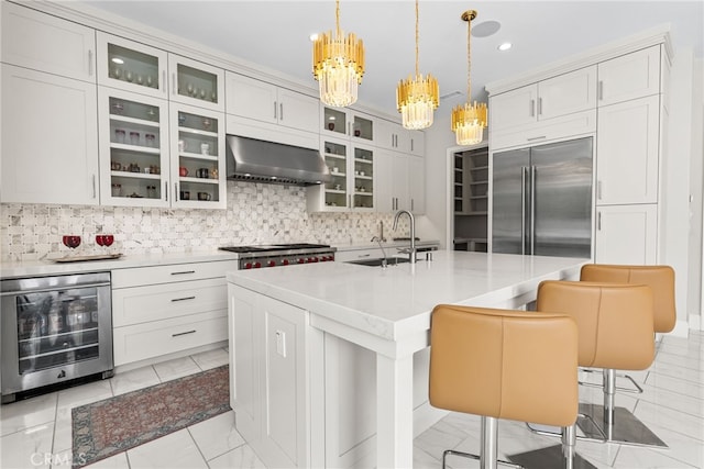 244 Coal Mine, Irvine, CA 92602 - kitchen with wall chimney exhaust hood, beverage cooler, a sink, built in fridge, and a chandelier