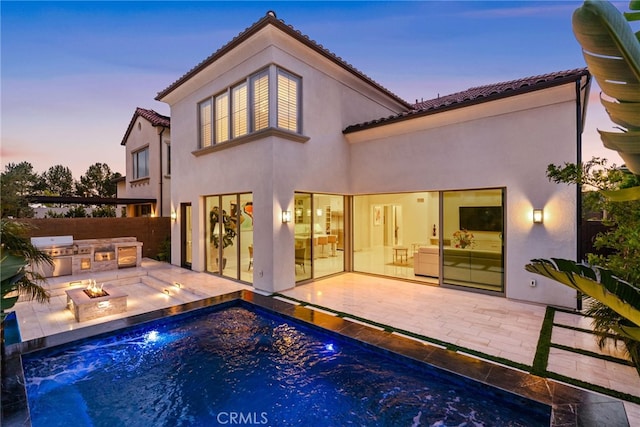 244 Coal Mine, Irvine, CA 92602 - rear view of property featuring exterior kitchen, stucco siding, and a tile roof