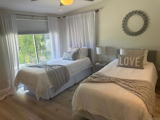 bedroom with wood finished floors and recessed lighting