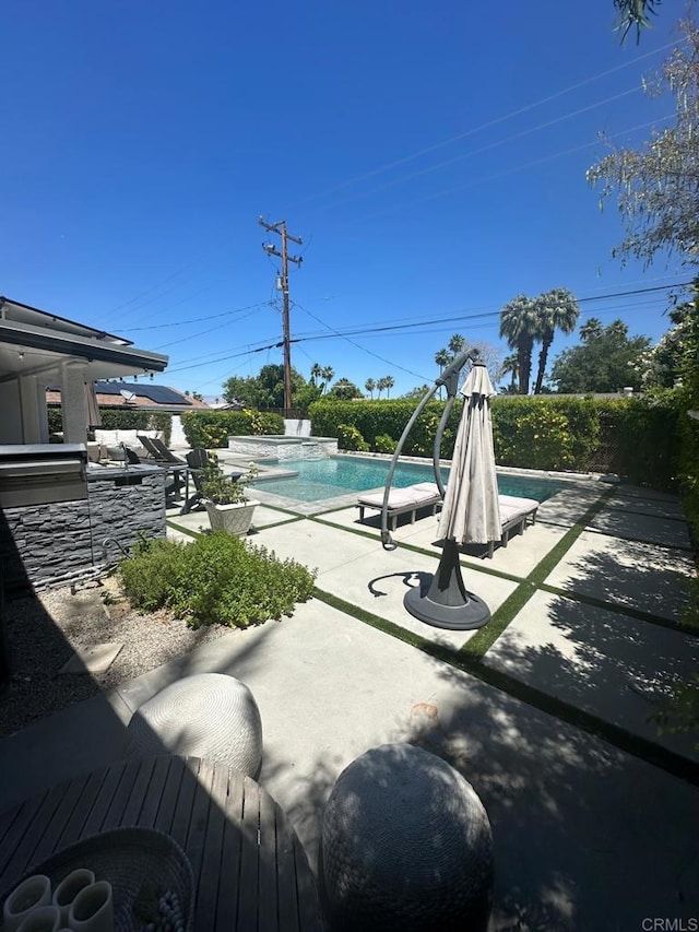 view of swimming pool with a patio and a jacuzzi