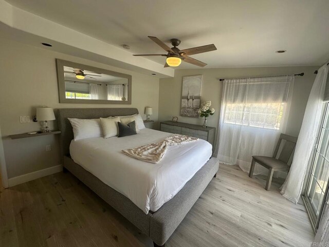 bedroom featuring light wood-type flooring, ceiling fan, and baseboards