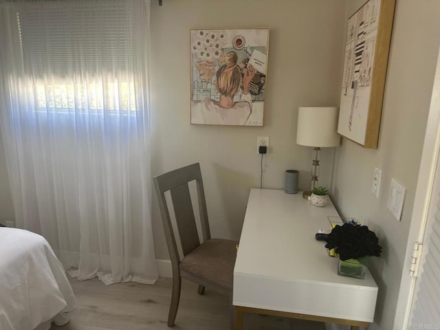 home office with wood finished floors and baseboards