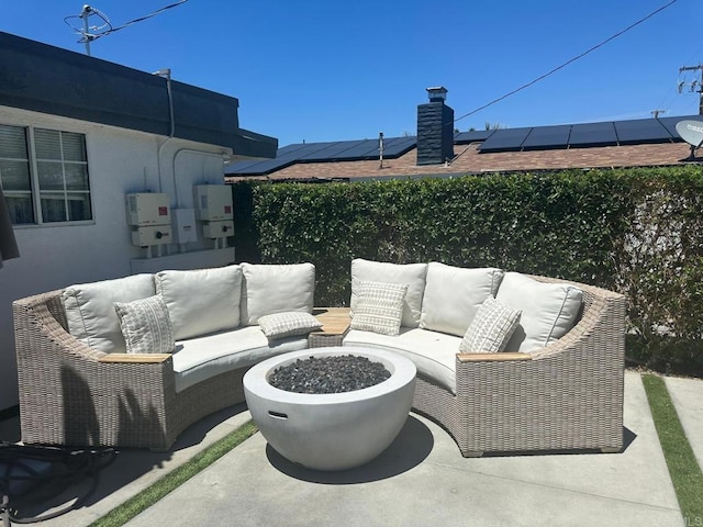 view of patio with an outdoor living space with a fire pit