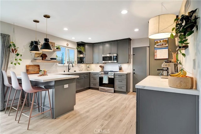 2447 Young Ave, Thousand Oaks, CA 91360 - kitchen with stainless steel appliances, gray cabinets, open shelves, a peninsula, and decorative backsplash
