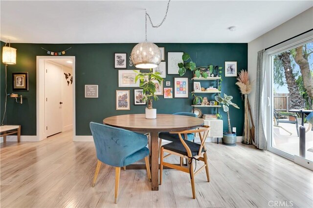 2447 Young Ave, Thousand Oaks, CA 91360 - dining room featuring light wood-style floors, an accent wall, and baseboards