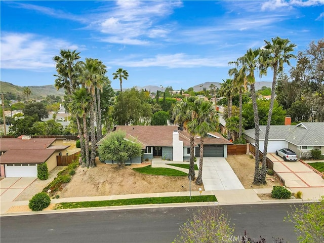 2447 Young Ave, Thousand Oaks, CA 91360 - view of front of property with concrete driveway, fence, an attached garage, a residential view, and a mountain view