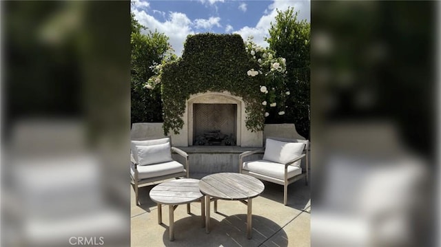 view of patio / terrace with exterior fireplace