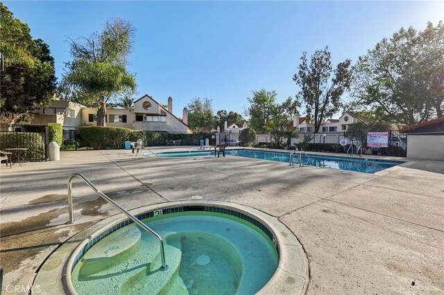 383 N Melrose Dr Unit G, Vista, CA 92083 - community pool featuring a hot tub, a residential view, fence, and a patio