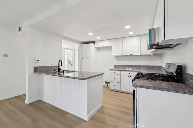 383 N Melrose Dr Unit G, Vista, CA 92083 - kitchen with a sink, light wood-style floors, a peninsula, white cabinets, and recessed lighting