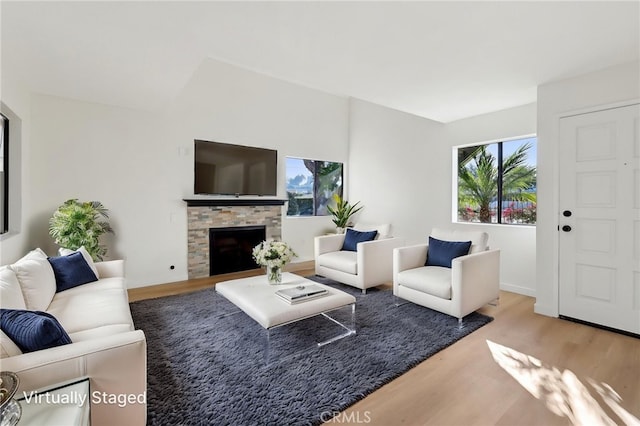 383 N Melrose Dr Unit G, Vista, CA 92083 - living area with wood finished floors, a fireplace, and baseboards